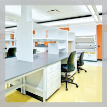 Case Western Reserve University Urology Building: Bright white lab casework, black chairs and fume hood with orange accent wall.